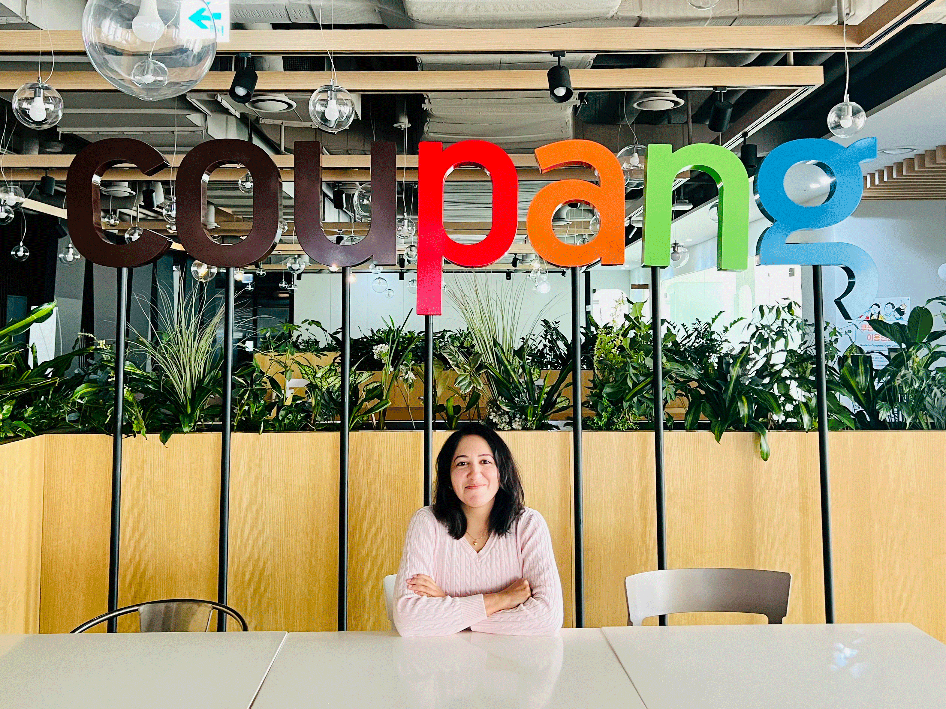 a person sitting at a table with arms crossed