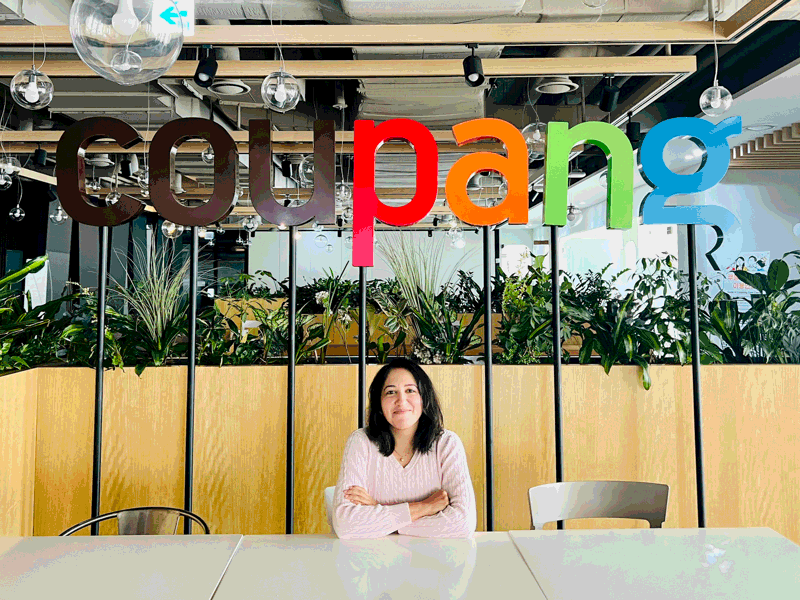 a person sitting at a table with arms crossed