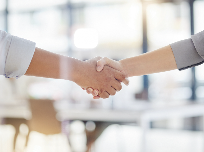 a close-up of people shaking hands