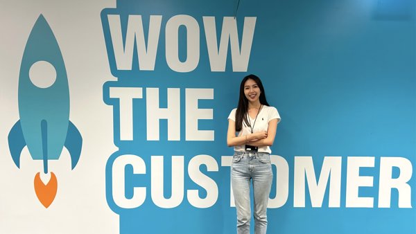 a person standing in front of a wall with white text