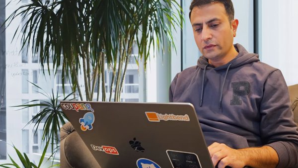 a person sitting on a couch using a laptop