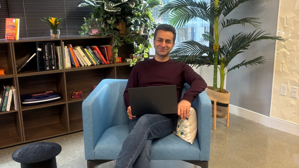 a person sitting in a chair with a laptop