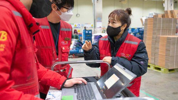 a person and person wearing face masks and red vests