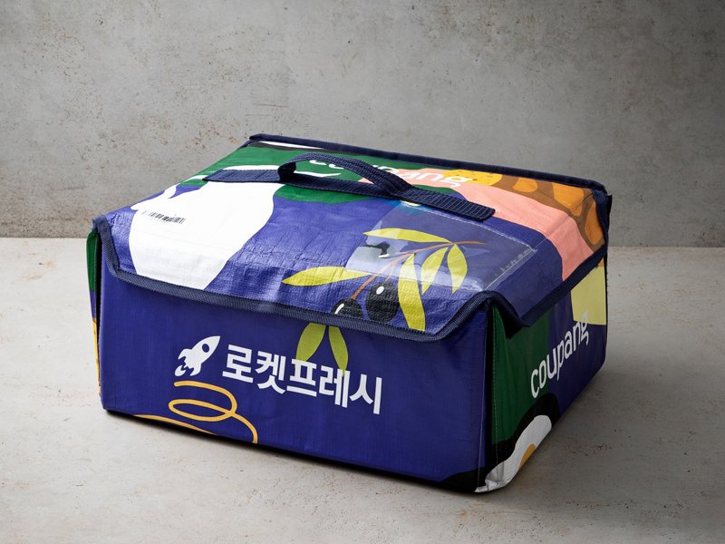 a blue and green bag with white text and a blue handle