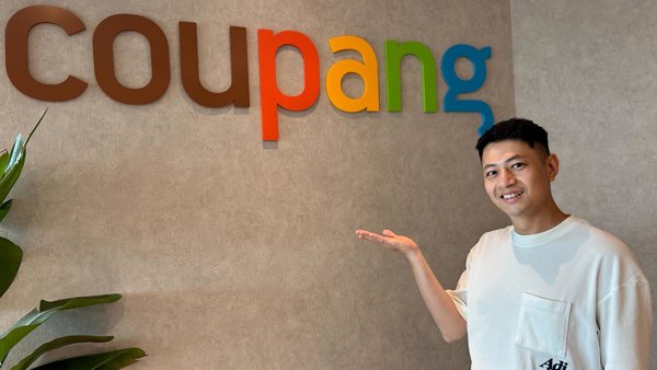 a person standing in front of a sign