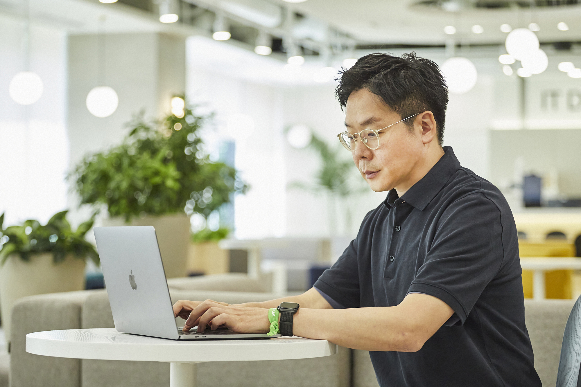 a person sitting at a table using a laptop