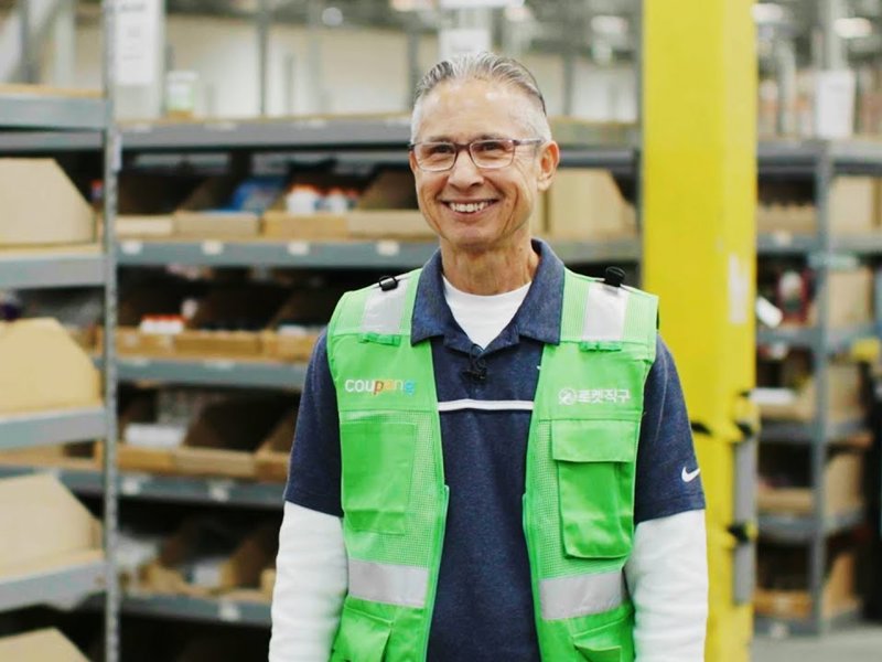 a person in a green vest