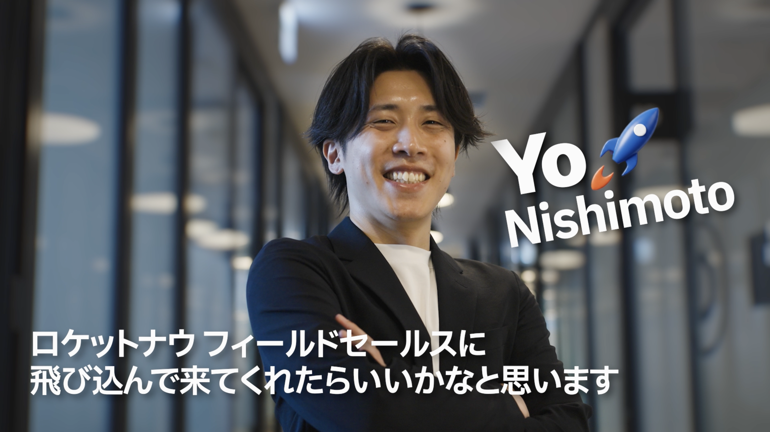 腕を組んで微笑む人物