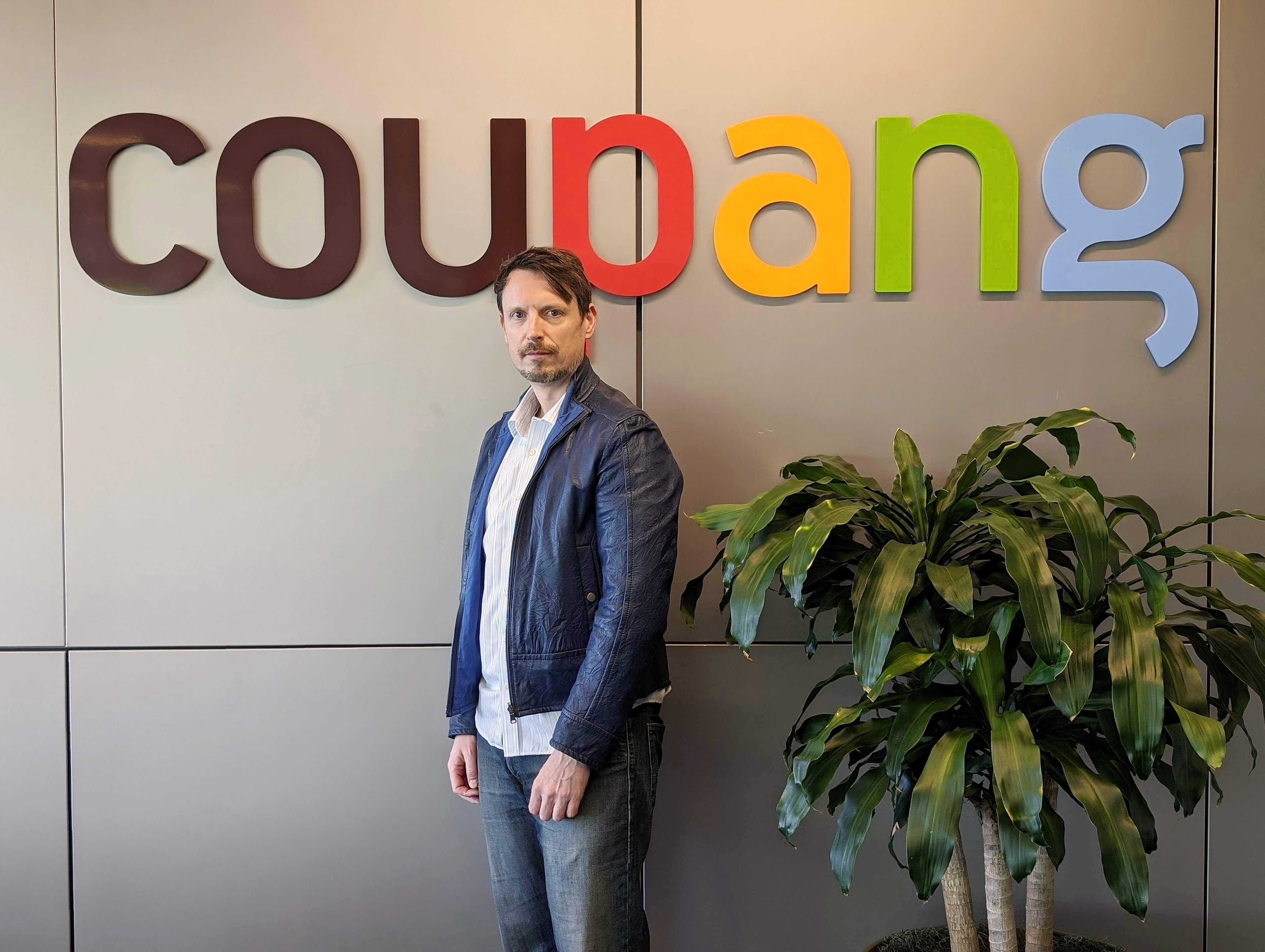 a person standing in front of a sign