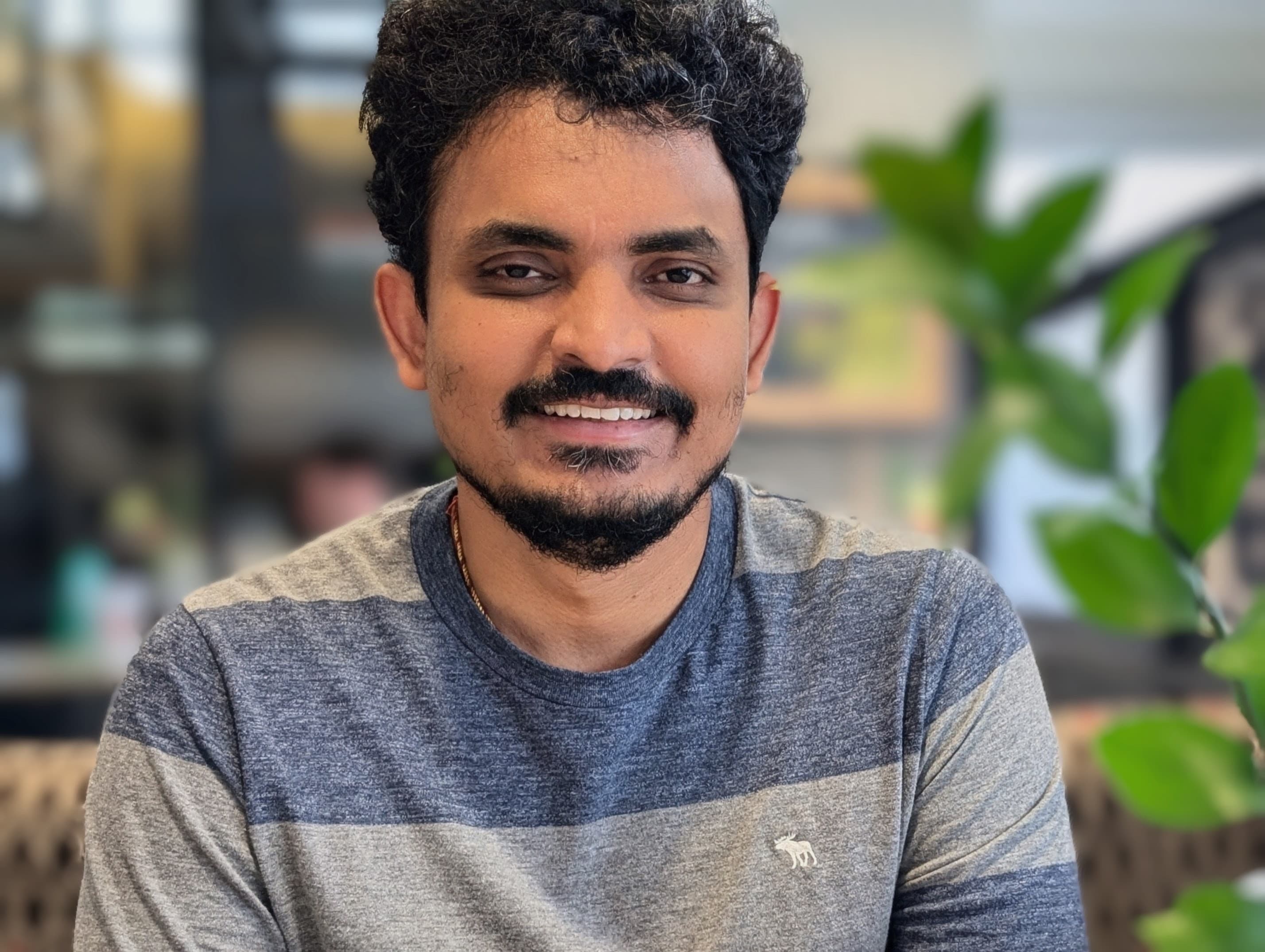 a person with a mustache and beard smiling