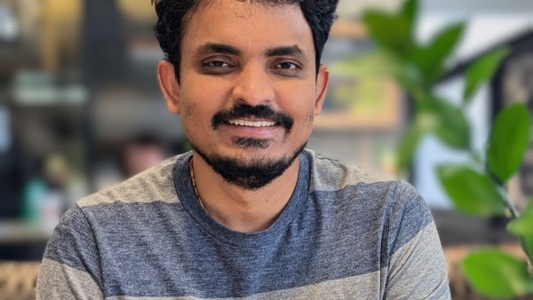 a person with a mustache and beard smiling