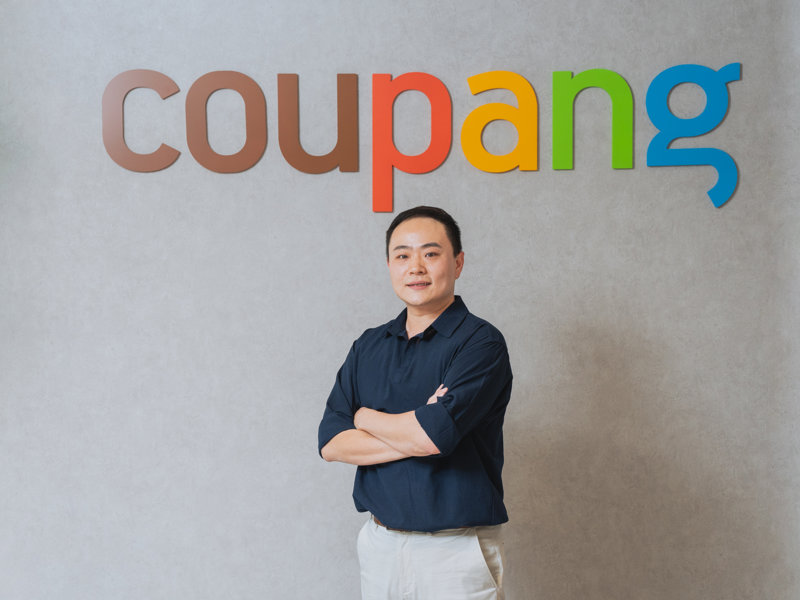 a person standing in front of a sign