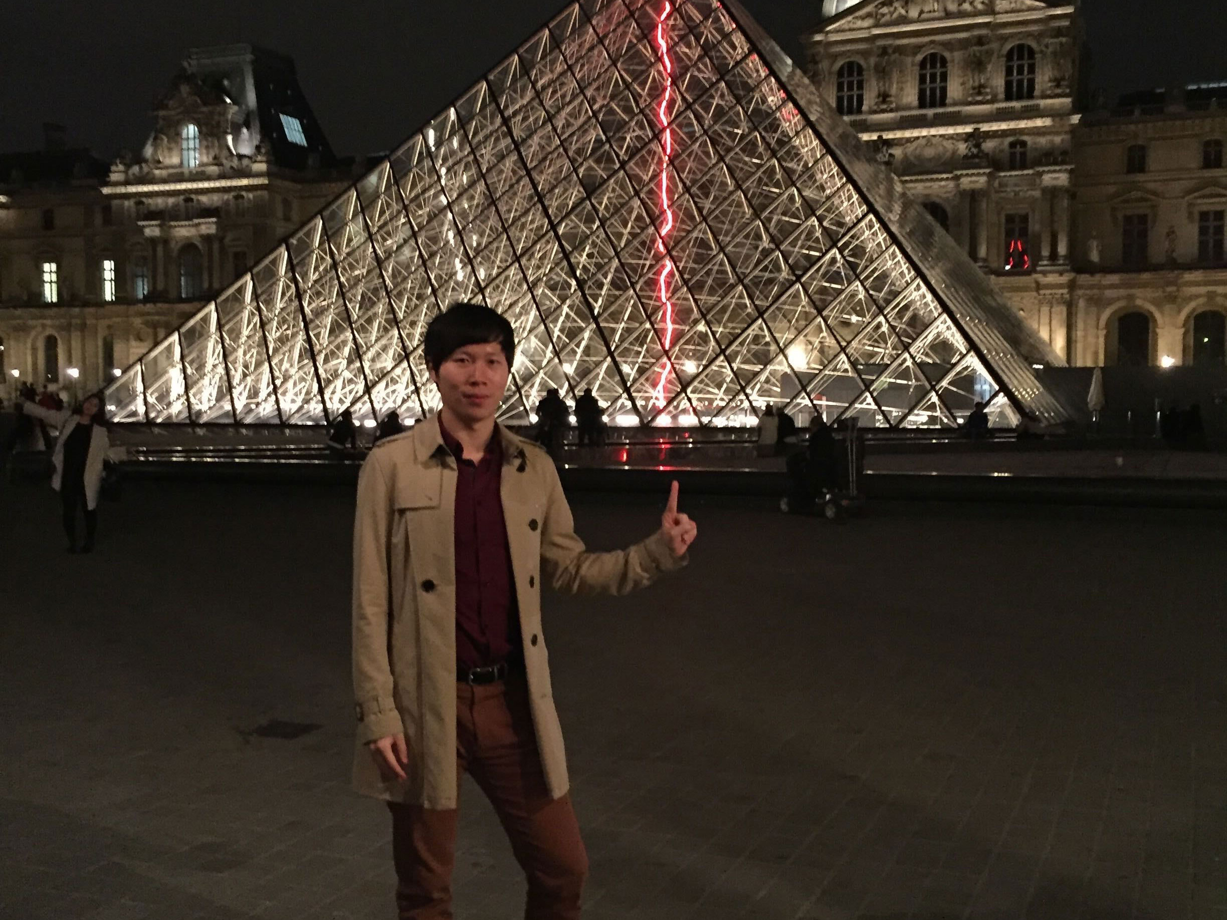 a person standing in front of a pyramid