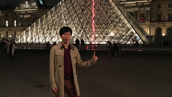 a person standing in front of a pyramid