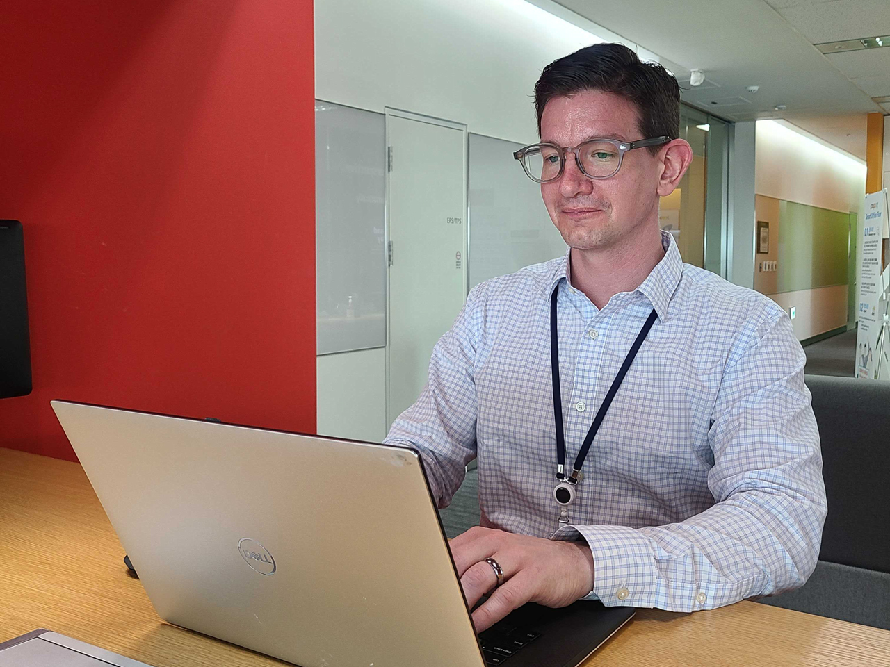 a person sitting at a desk with a laptop
