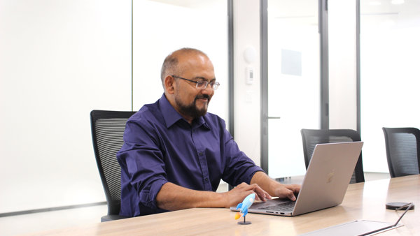 a person sitting at a desk with a laptop
