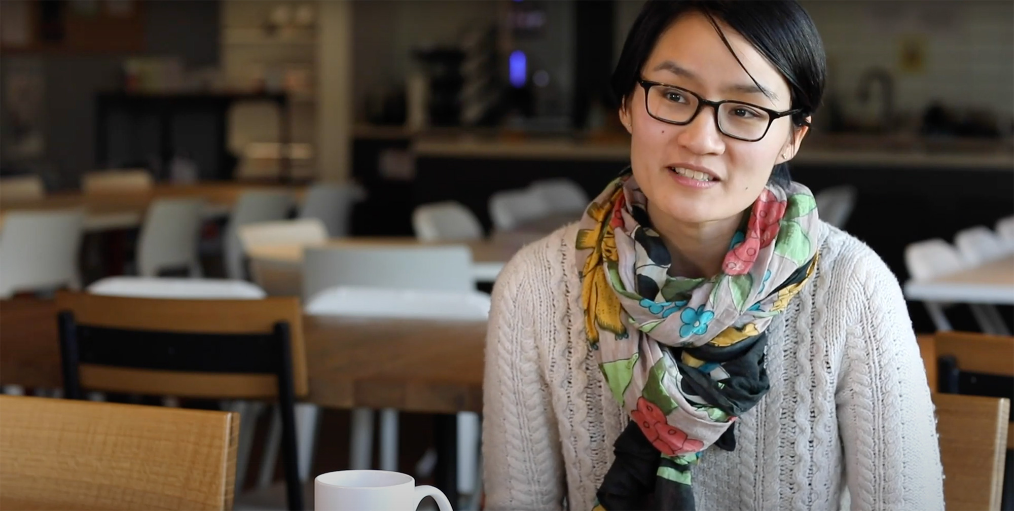 a person wearing glasses and a scarf