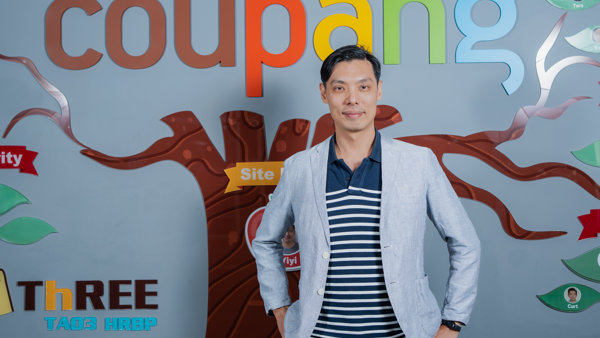 a person standing in front of a sign