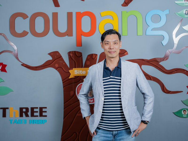 a person standing in front of a sign