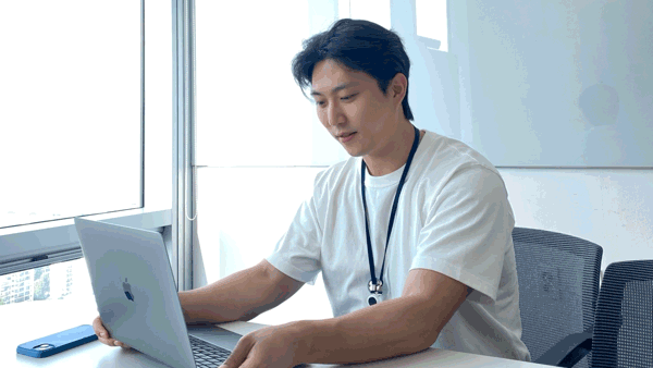 a person sitting at a desk with a laptop
