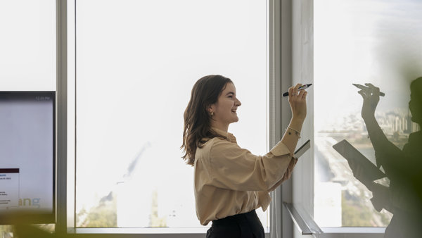 a person writing on a whiteboard
