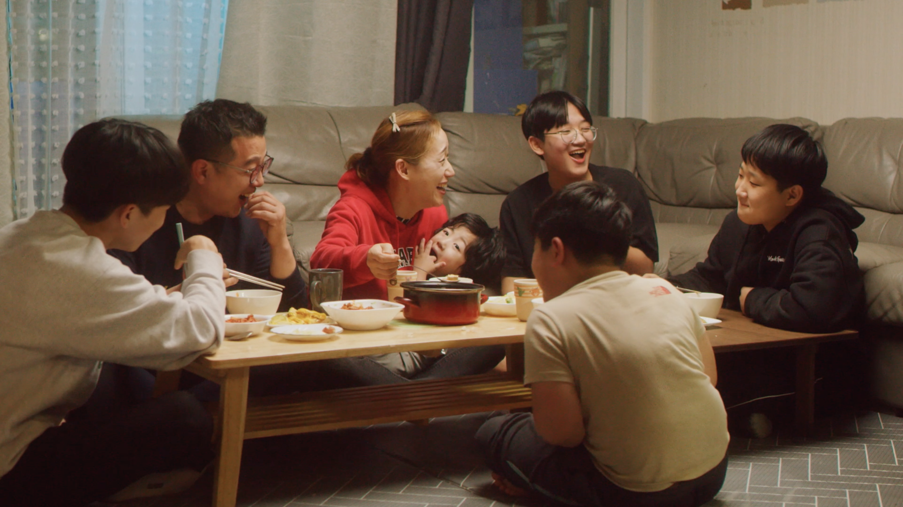 a group of people sitting around a table eating food