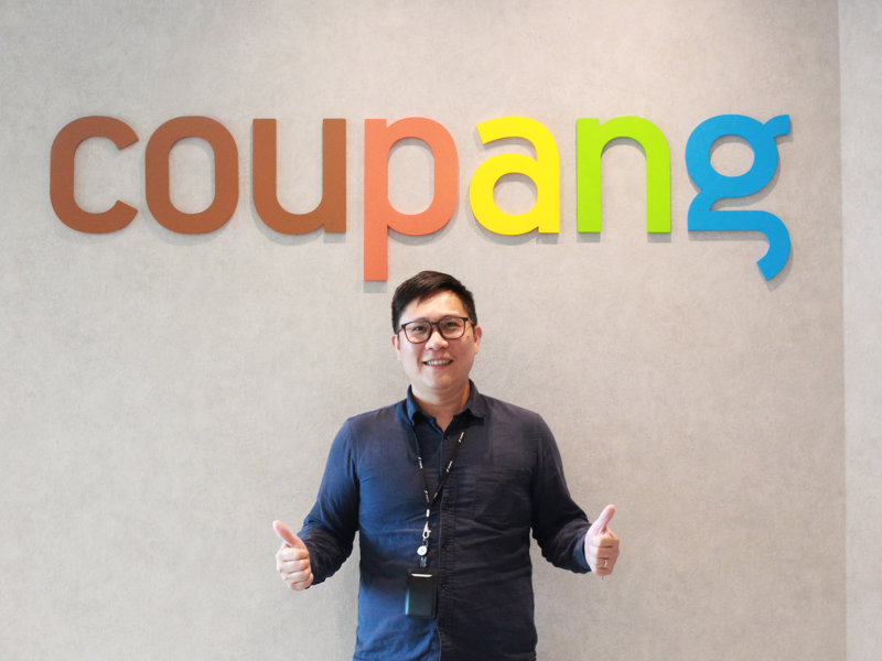 a person standing in front of a sign