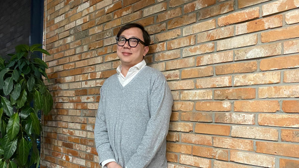 a person leaning against a brick wall