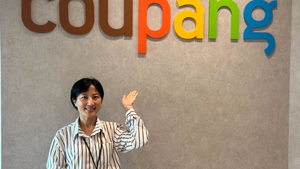 a person standing in front of a sign