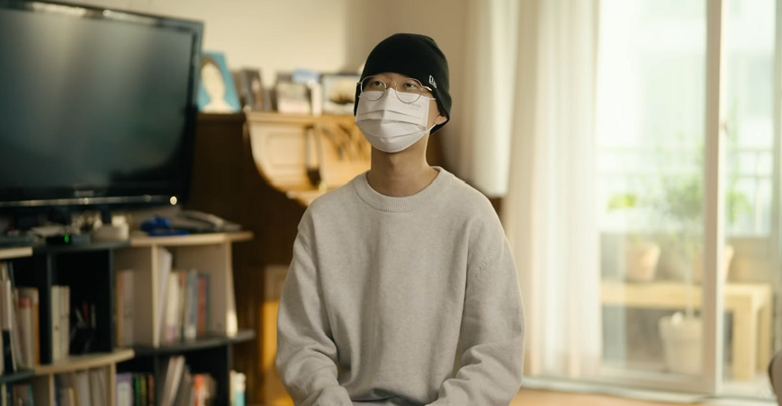 a person wearing a mask and a beanie