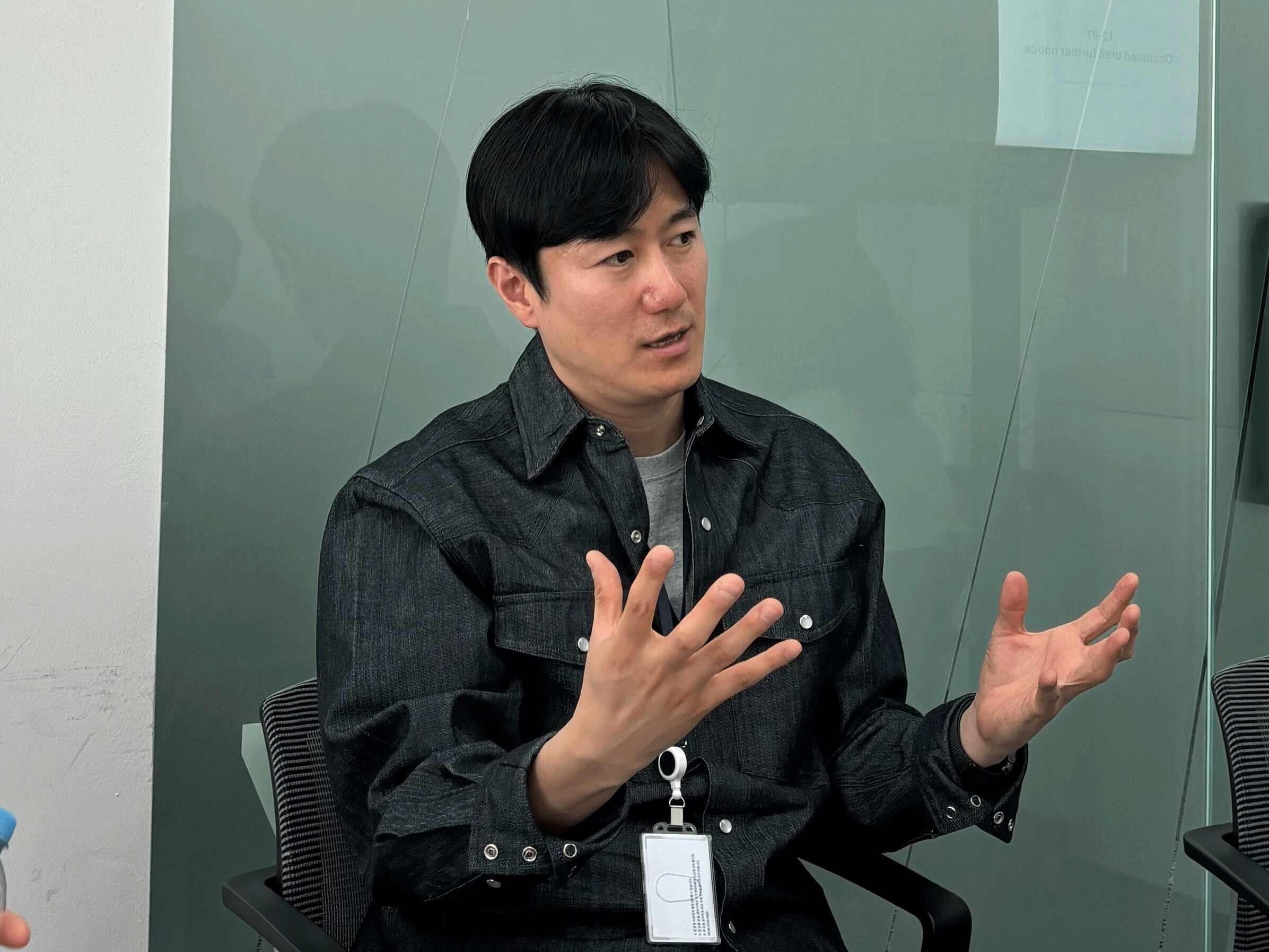 a person sitting in a chair with his hands up