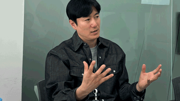 a person sitting in a chair with his hands up