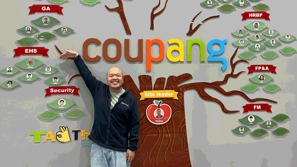 a person standing in front of a wall with a tree and persony images