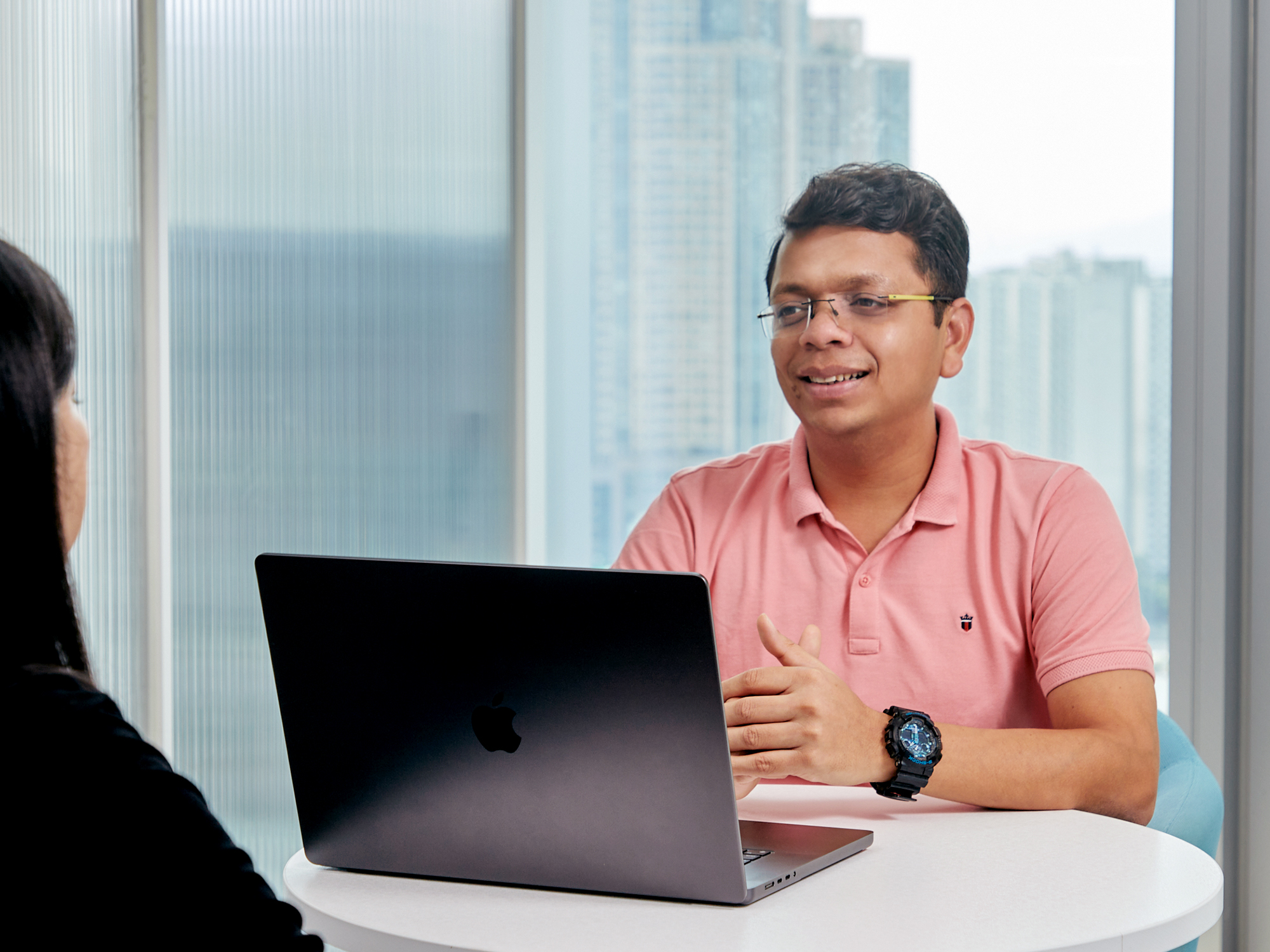a person sitting at a table with a laptop