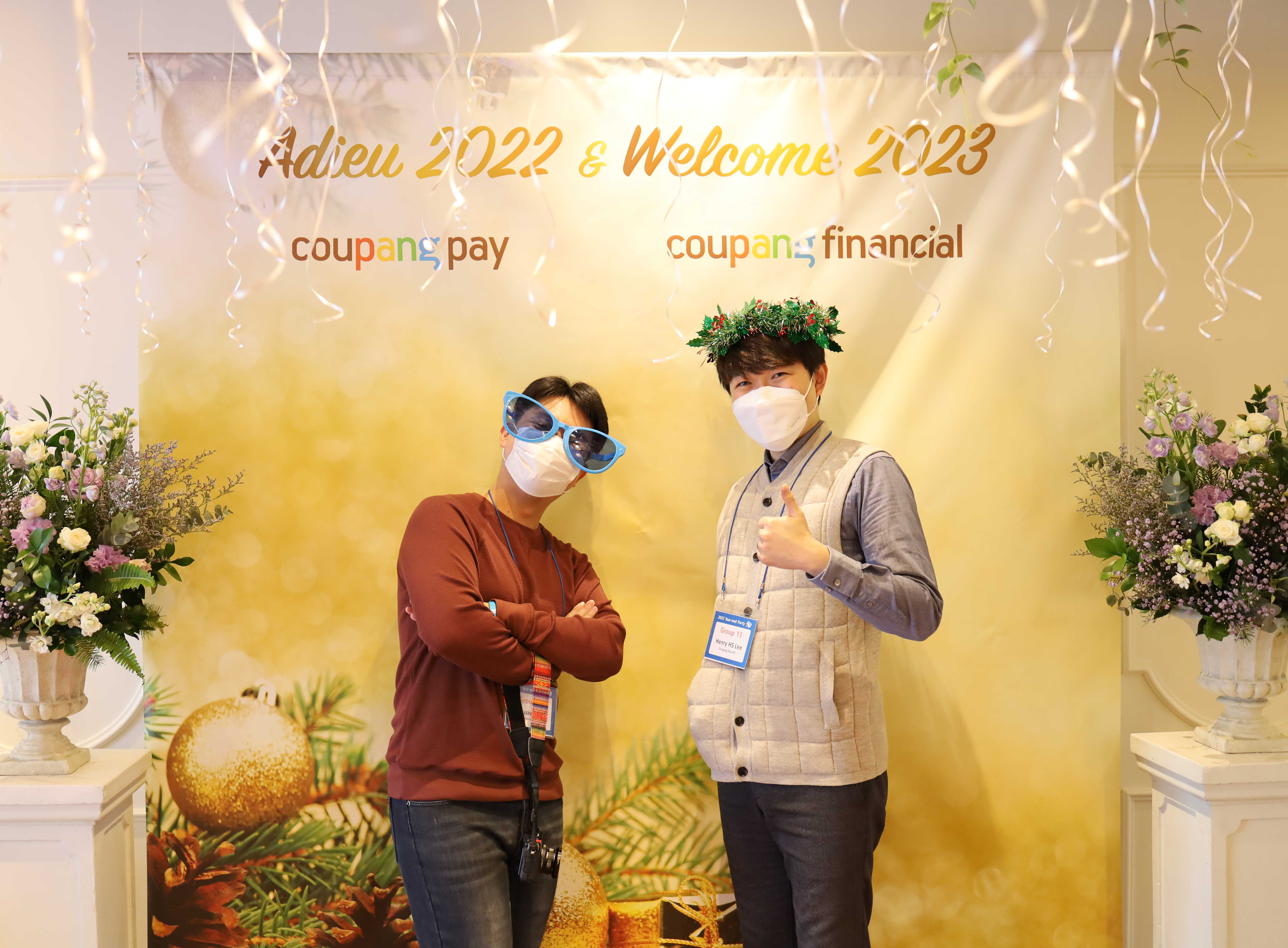 two men standing in front of a sign