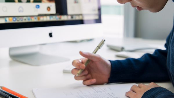 a person writing on a piece of paper