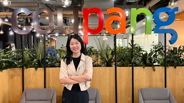 a person standing in front of a sign