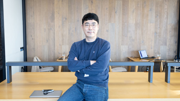 a person sitting on a table with his arms crossed