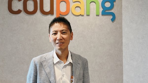 a person standing in front of a sign