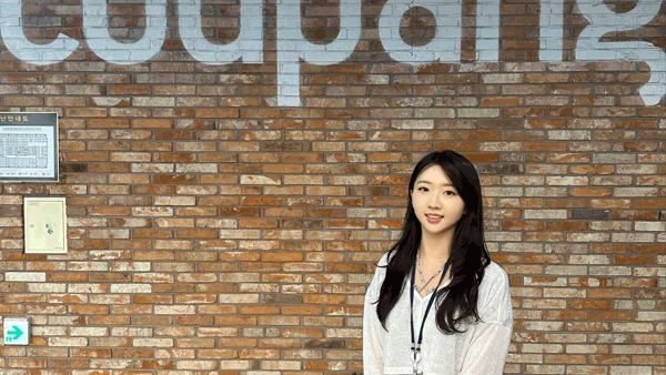 a person standing in front of a brick wall