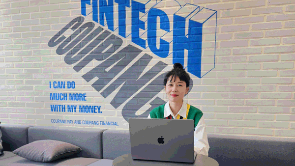 a person sitting at a table with a laptop