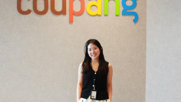 a person standing in front of a sign