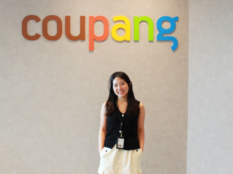 a person standing in front of a sign
