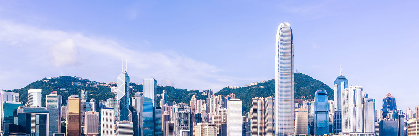 a city skyline with tall buildings and a body of water