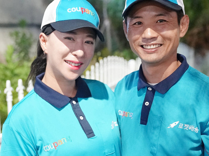 a person and person wearing matching blue shirts and hats