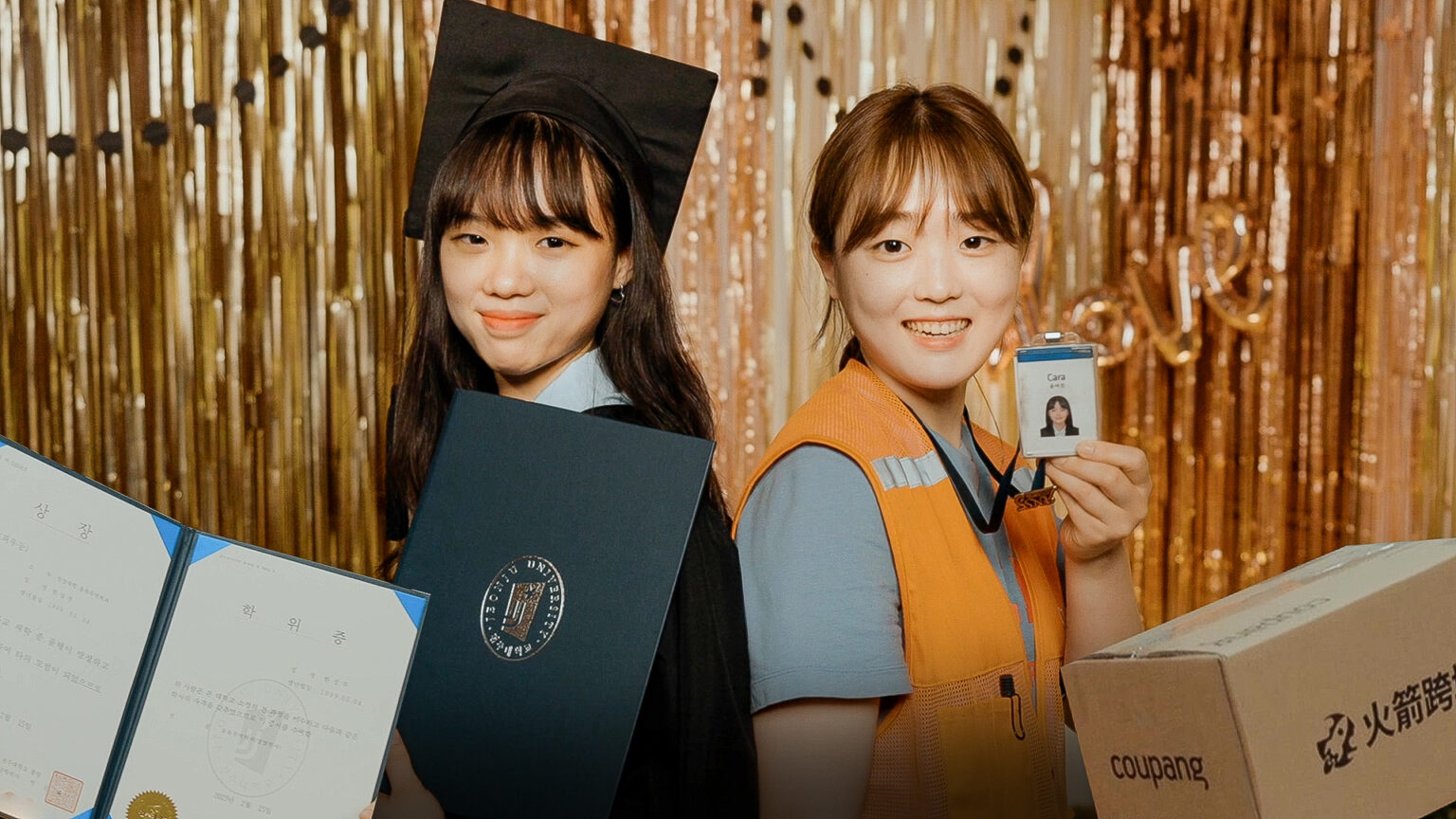 two women holding diplomas and a badge
