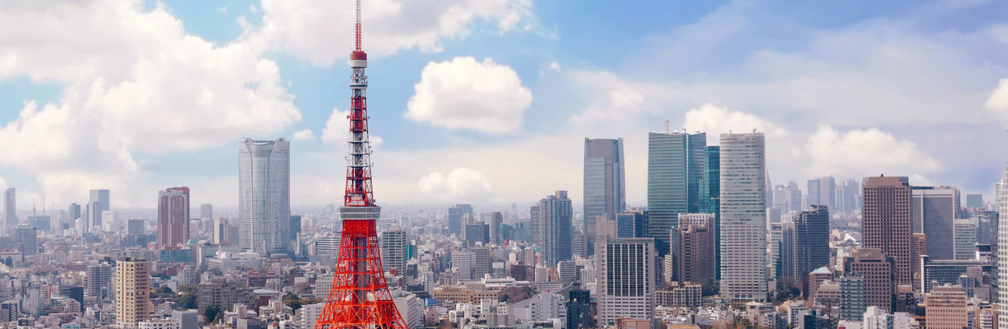 a large red and white tower in a city