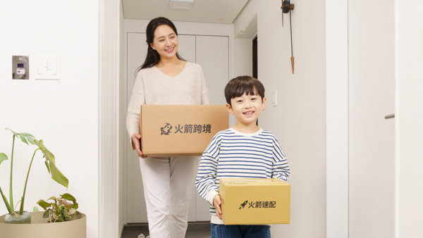 a person and a child holding boxes
