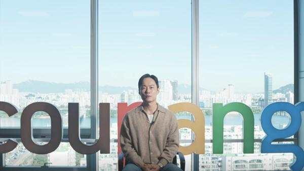 a person sitting in front of a large window