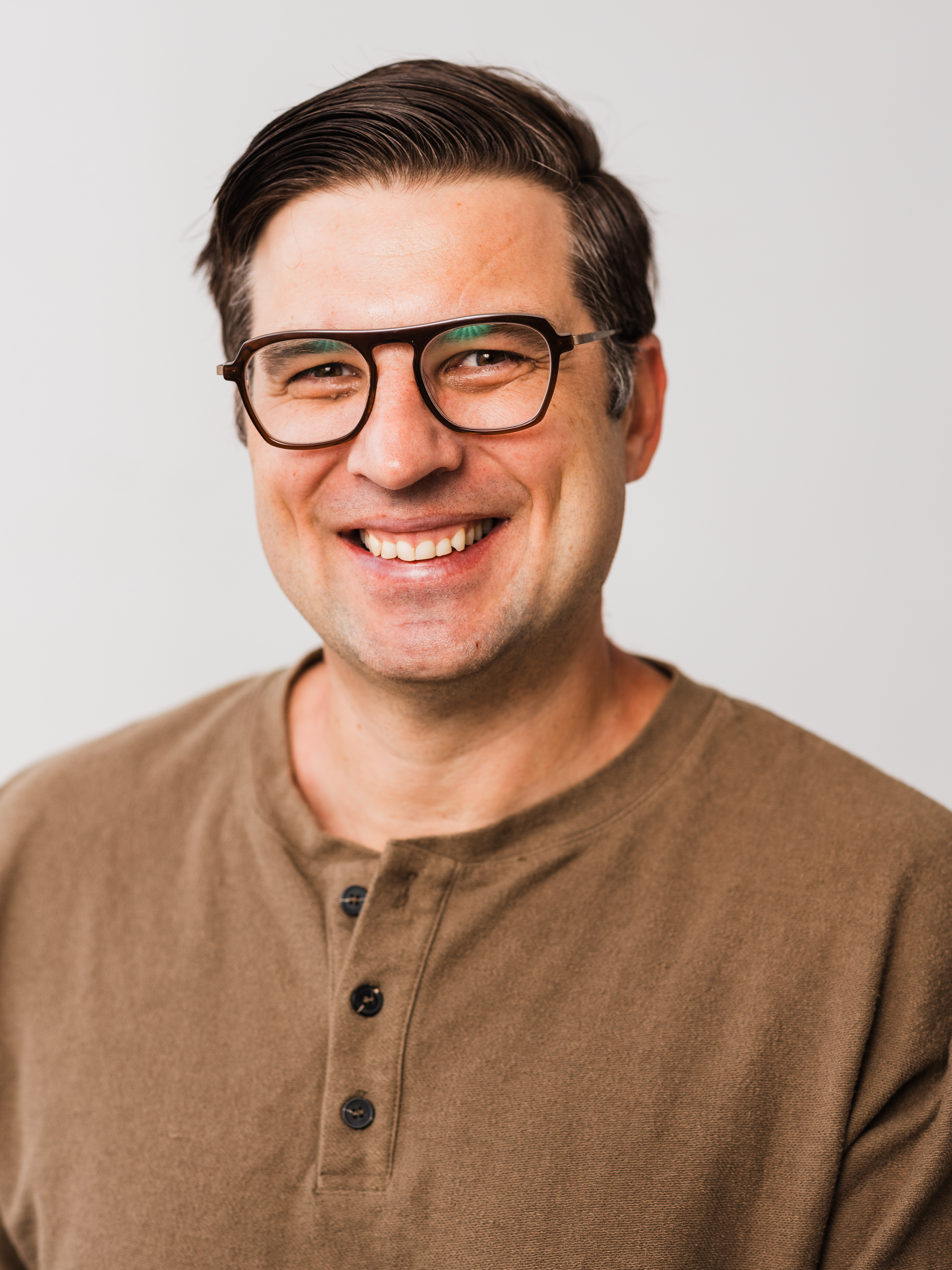 a person wearing glasses smiling
